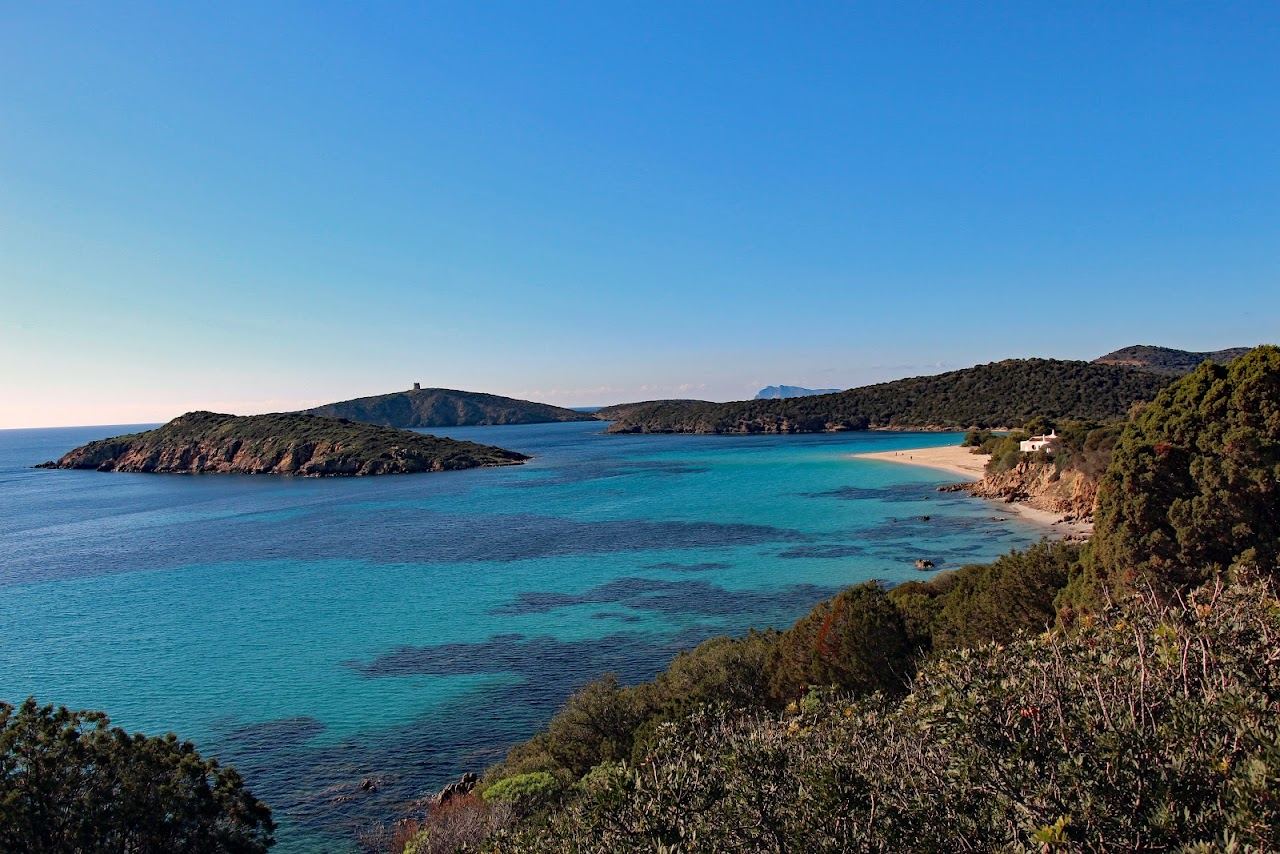 The bright flat water and white sand of Tuerredda beach in southern Sardinia