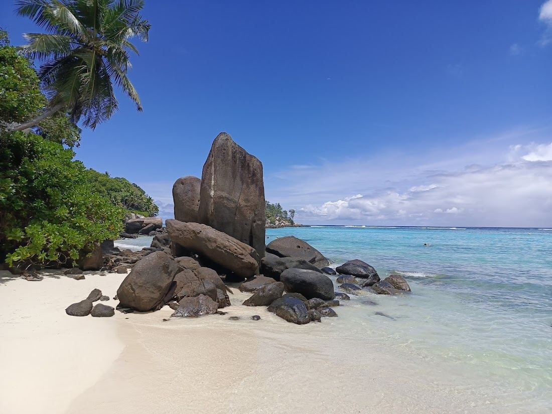 The reef calmed water and offshore islet of Anse Royale on Mahe