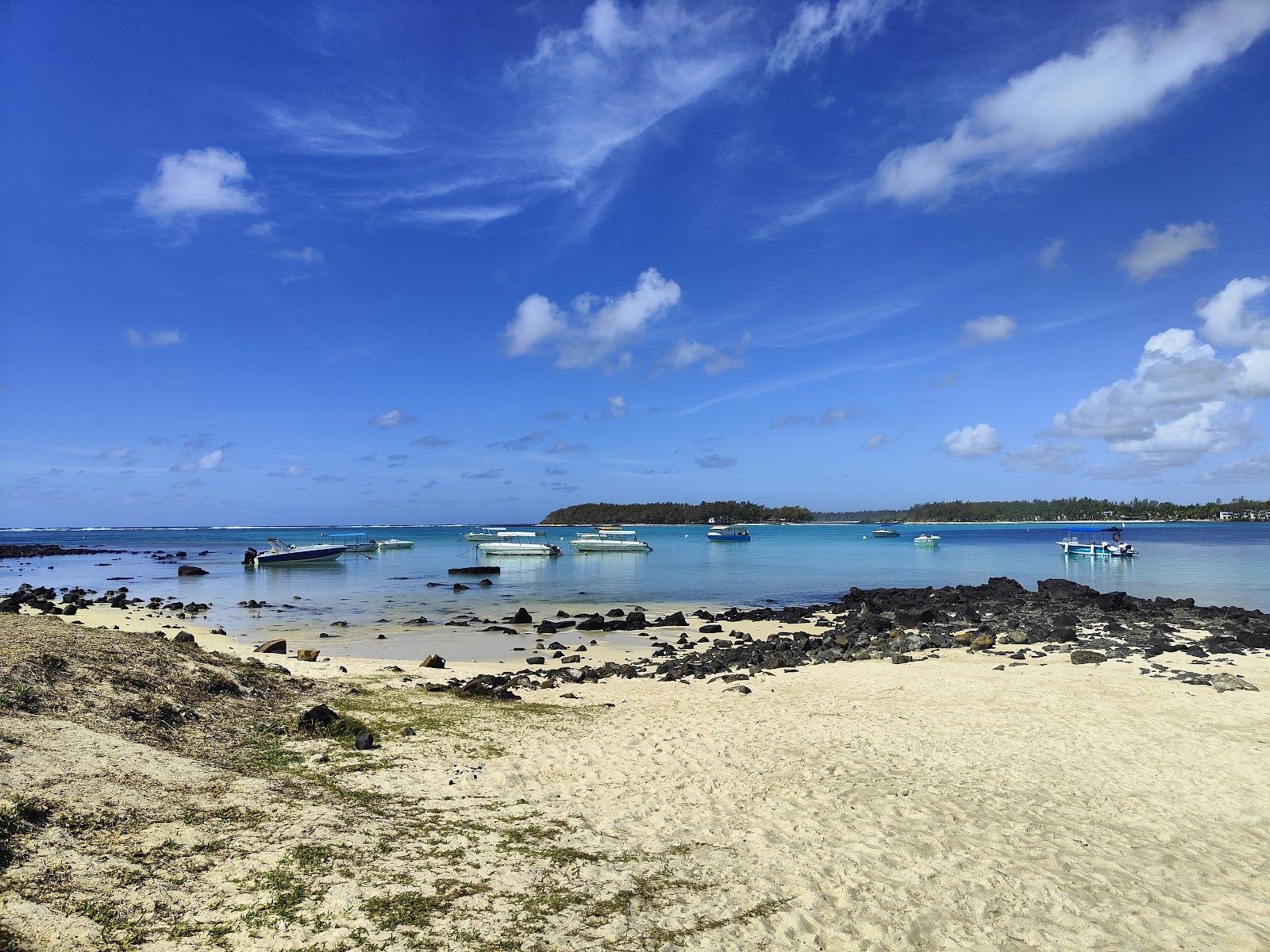The glassy protected lagoon and clear shallow water of Blue Bay in Mauritius