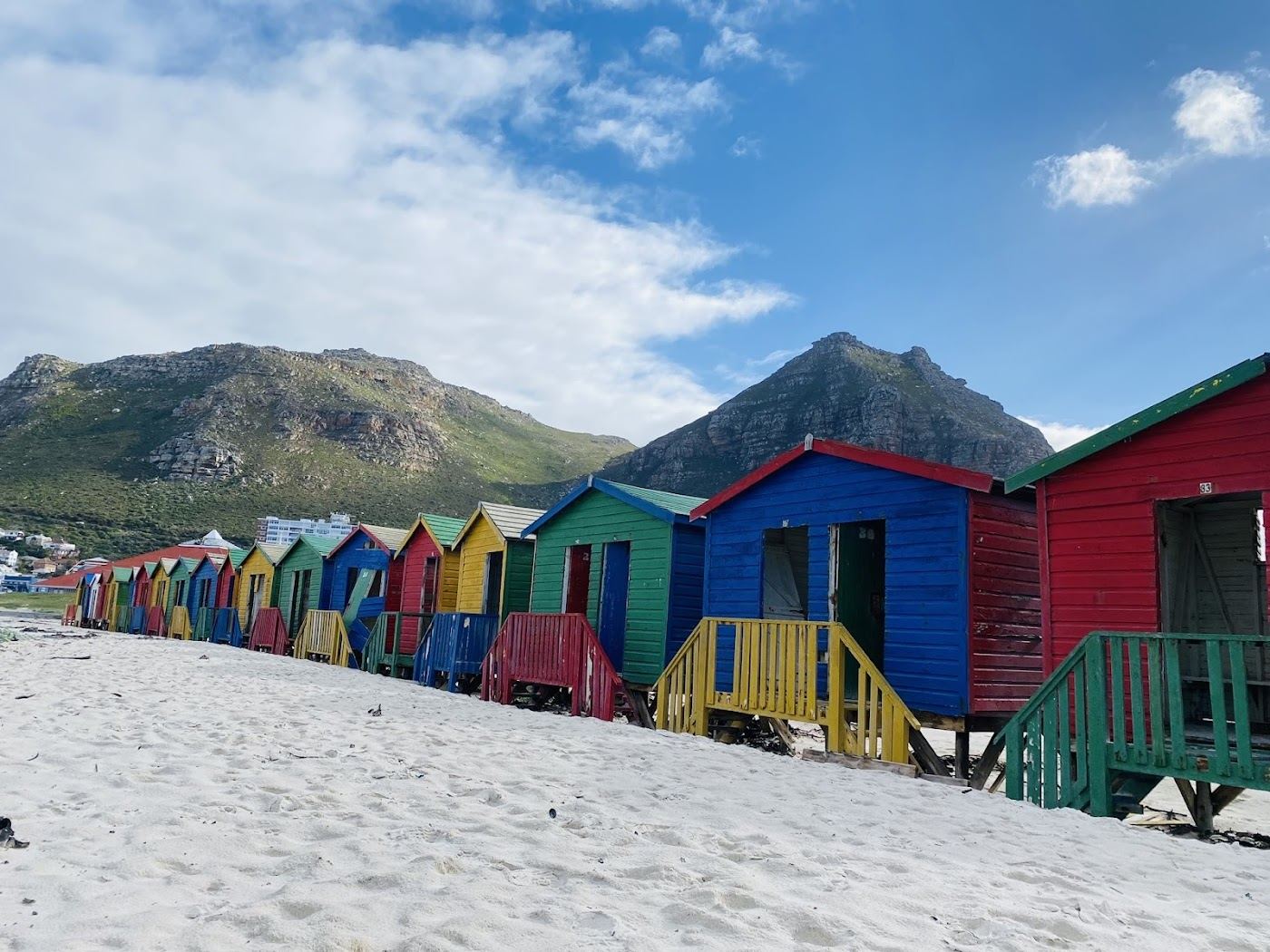 Free public sand and colourful bathing huts at Muizenberg beach in Cape Town