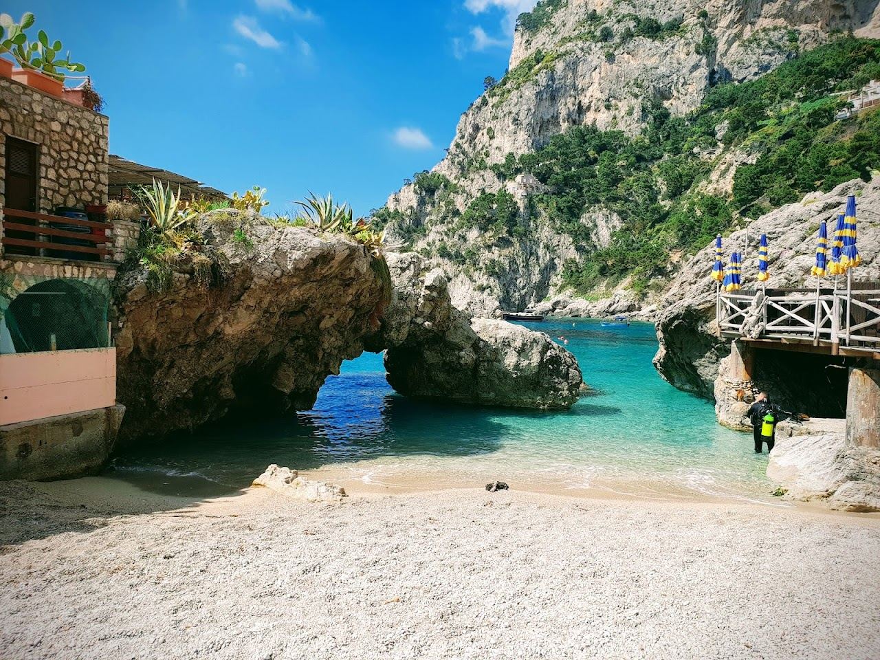 Pebble cove at Marina Piccola looking out to the Faraglioni rocks in Capri