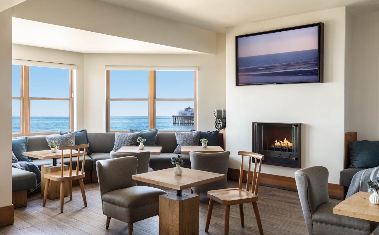 Terrace tables at Carbon Beach Club overlooking the sand and the Pacific at the Malibu Beach Inn