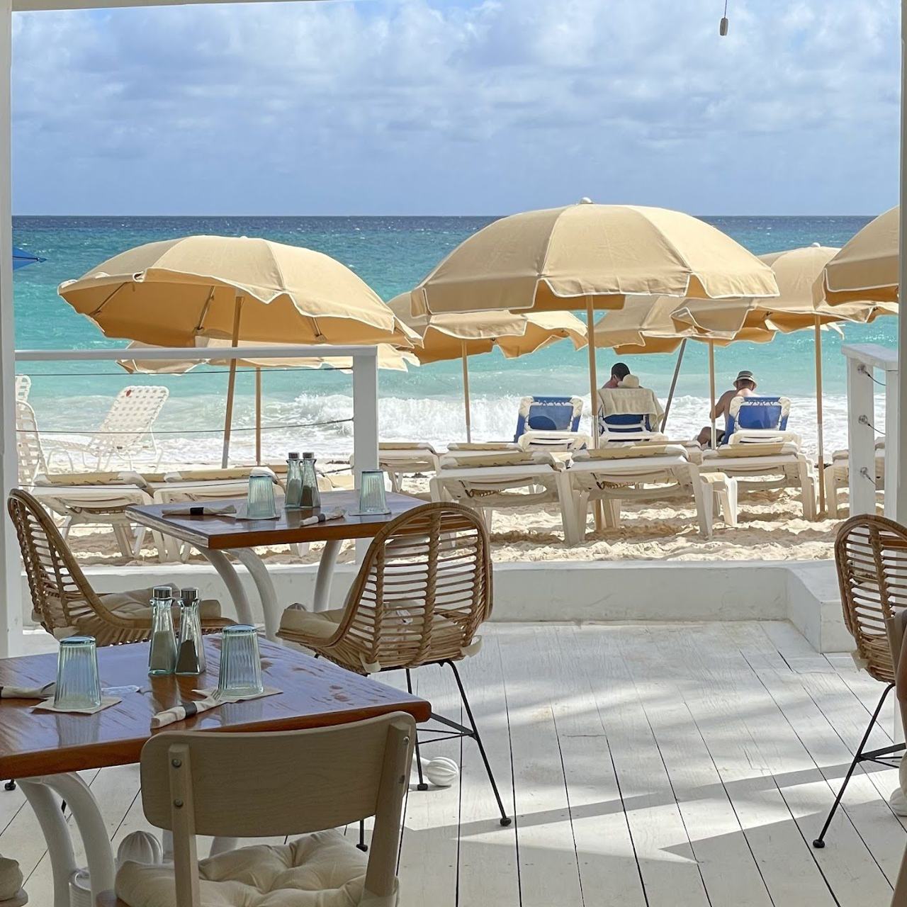A stylish beach club with loungers and turquoise water on the south coast of Barbados