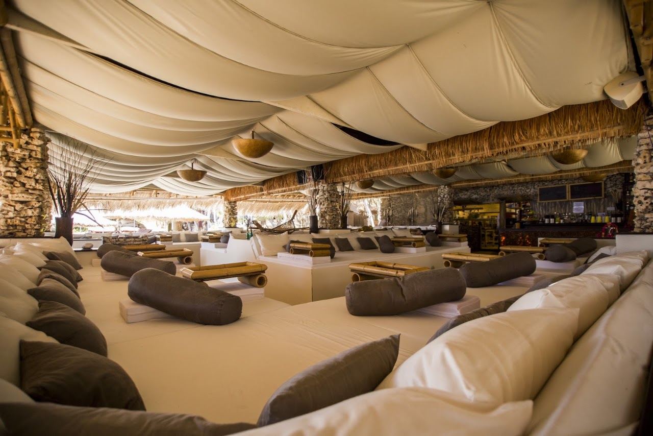 Cabanas and sunbeds above the clear water of Stipanska bay at Carpe Diem Beach off Hvar