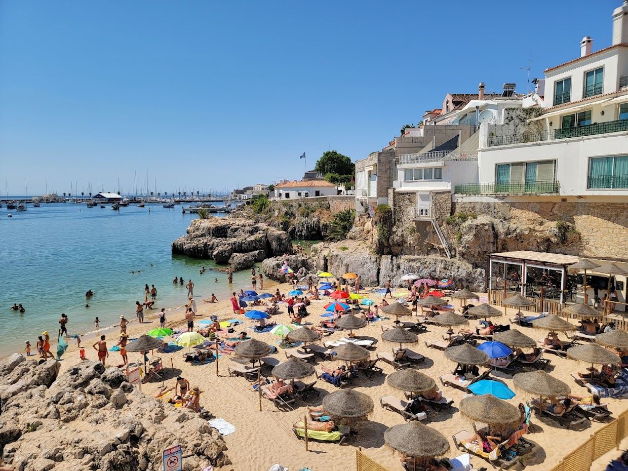 The sheltered central cove of Praia da Rainha framed by rock in the middle of Cascais