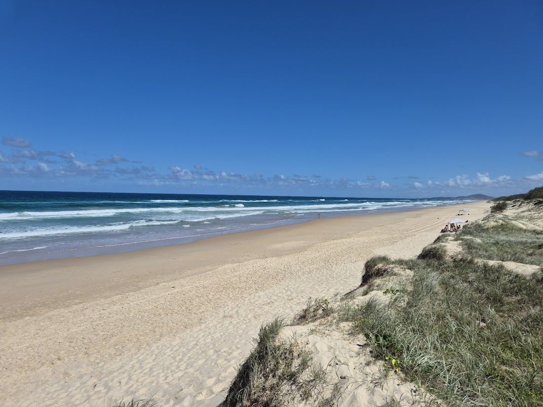 The quiet open sand and surf of Castaways Beach south of Noosa
