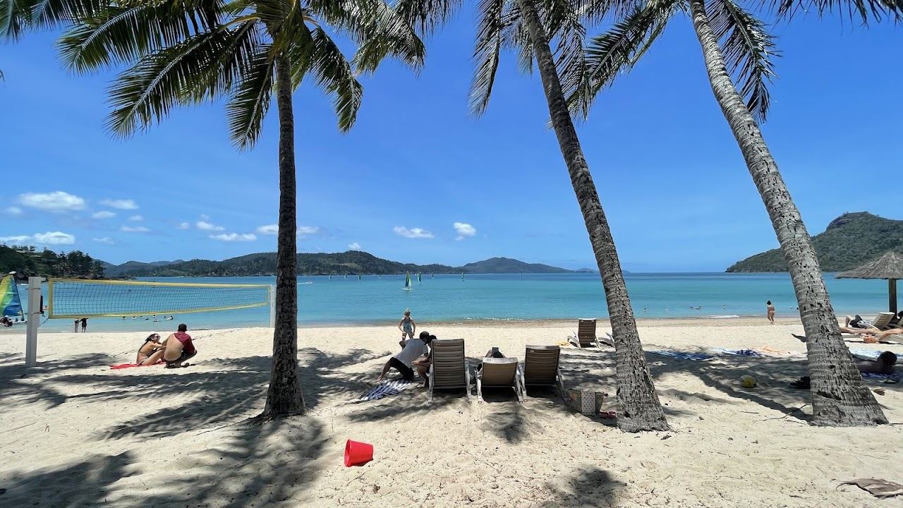 Palm fringed Catseye Beach and calm water on Hamilton Island in the Whitsundays