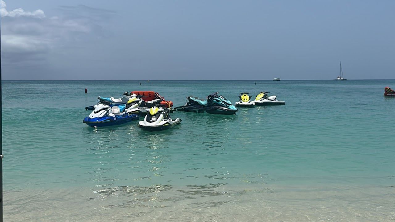 Paddleboards and clear calm water off Seven Mile Beach on the west coast of Grand Cayman