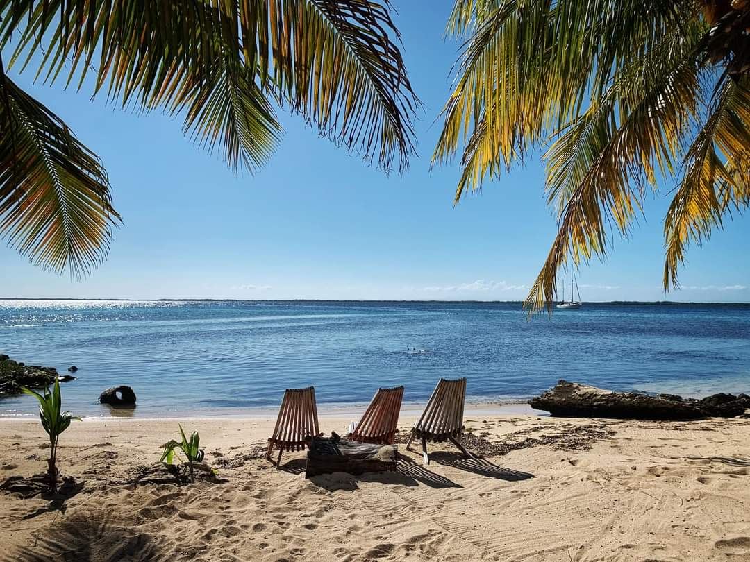 A long narrow spit of golden sand and calm water at Placencia on the Caribbean coast of Belize