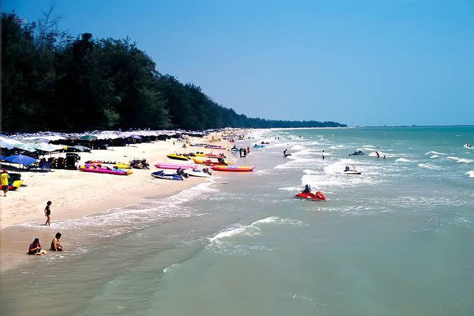 The long shallow sweep of Cha-Am Beach on the Gulf of Thailand north of Hua Hin
