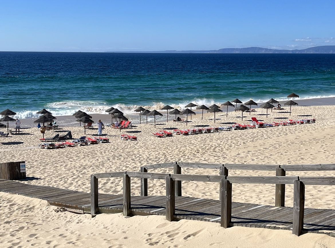 Wide pale sand backed by dunes under big Atlantic skies at Praia do Pego in Comporta