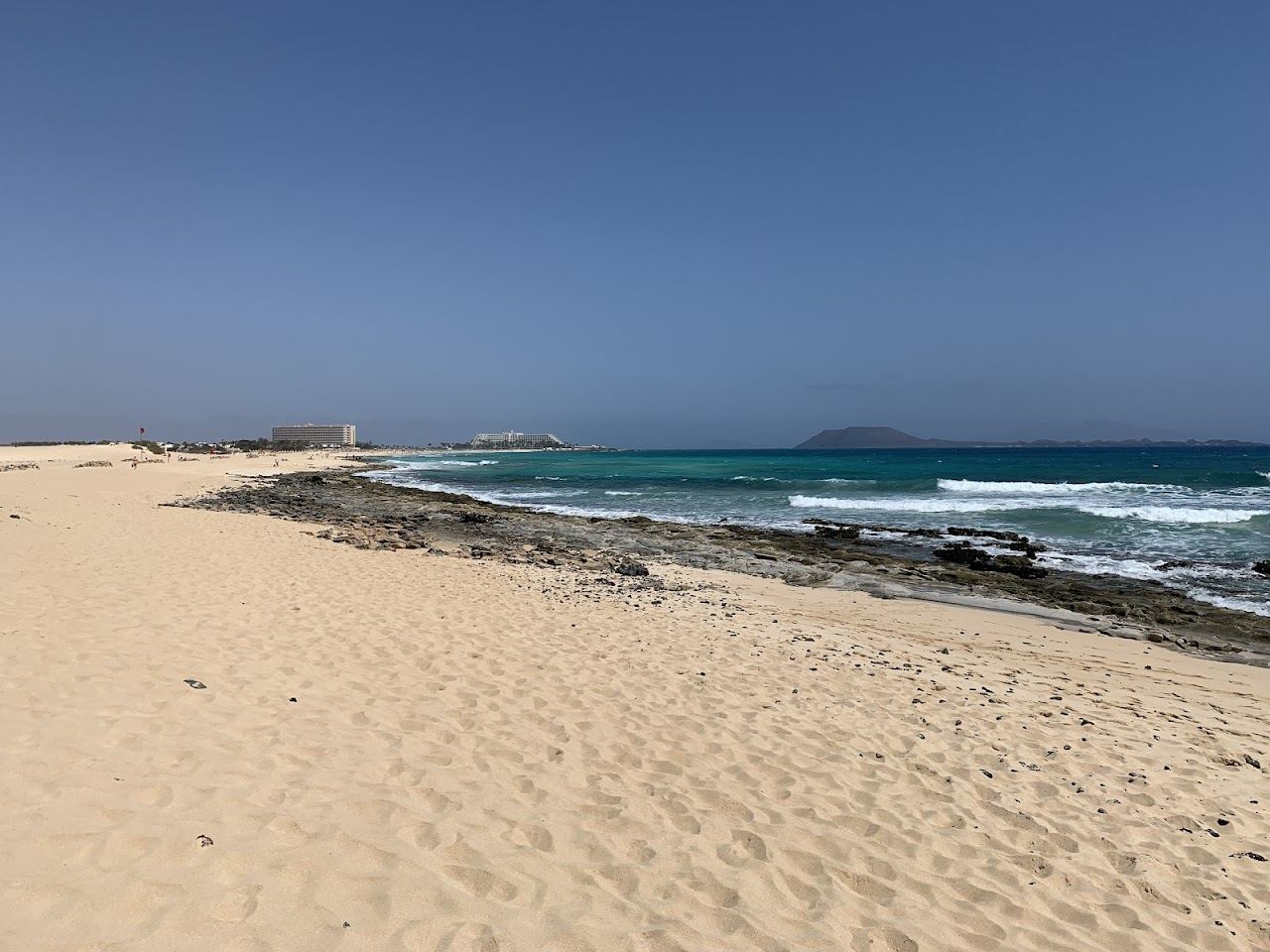 White sand dunes and turquoise water at the Grandes Playas de Corralejo in northern Fuerteventura