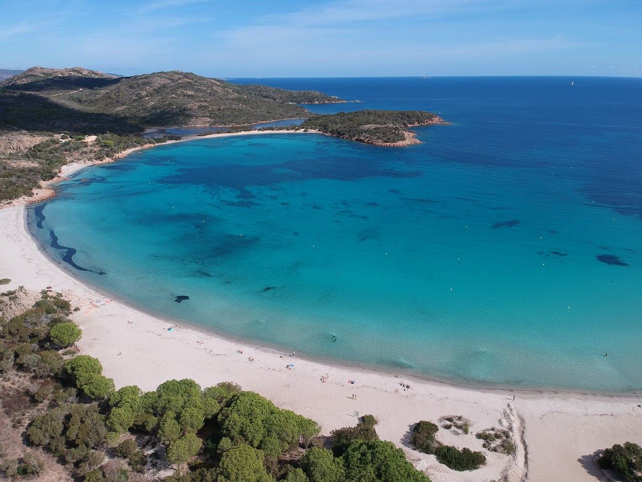 Clear turquoise water over rocks at a sheltered bay in southern Corsica