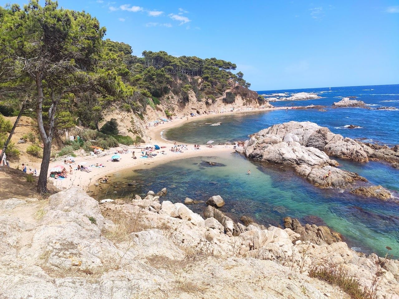 Clear turquoise water and pale pebble at a wild undeveloped cove near Palamos on the Costa Brava