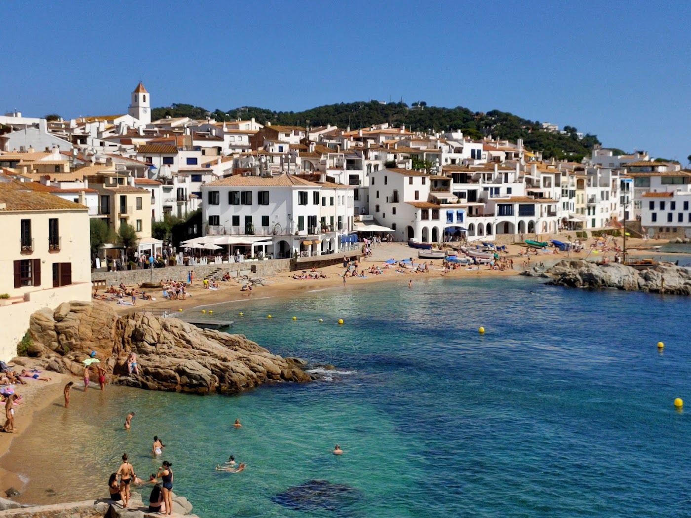 Whitewashed fishing village and clear cove water at Calella de Palafrugell on the Costa Brava