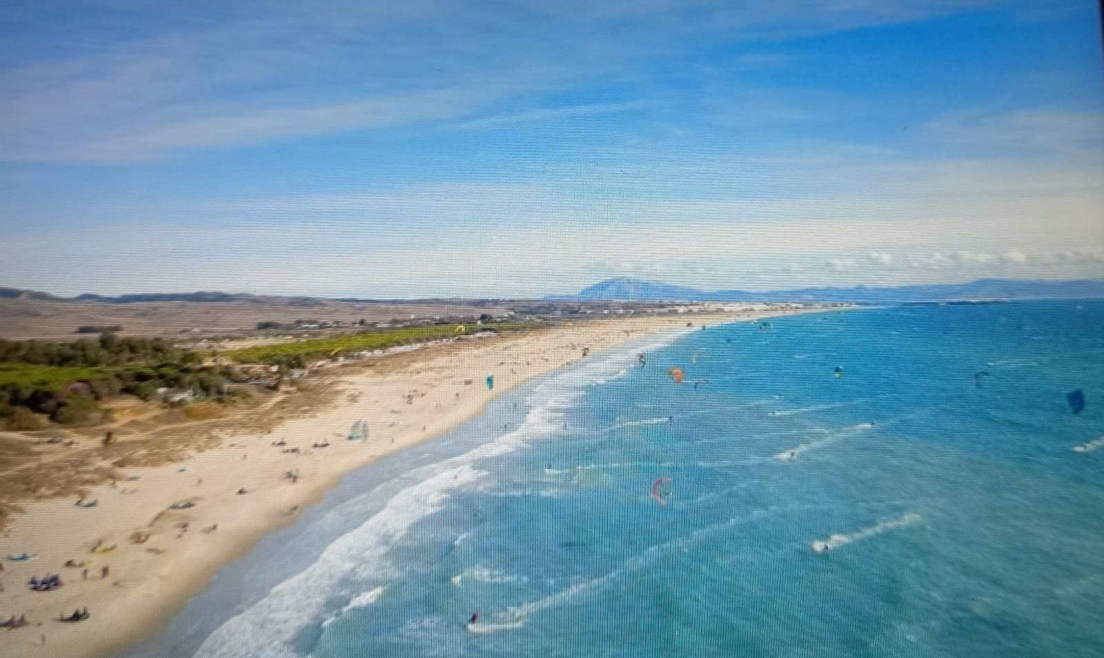 Kitesurfers and wind on the wide open sands of a Tarifa beach on the Costa de la Luz in Spain