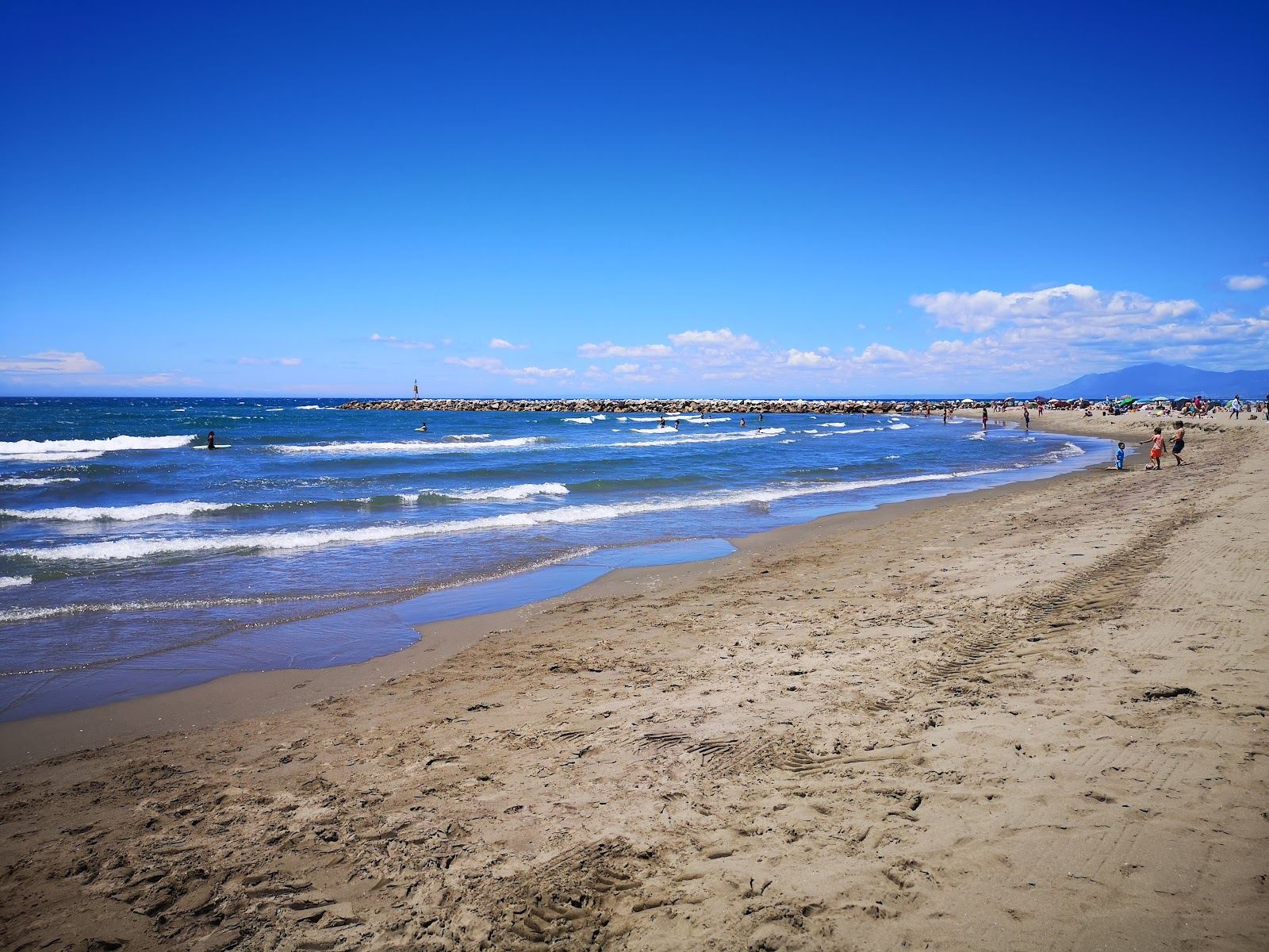 Pale dune backed sand and calm water at Cabopino beach near Marbella on the Costa del Sol