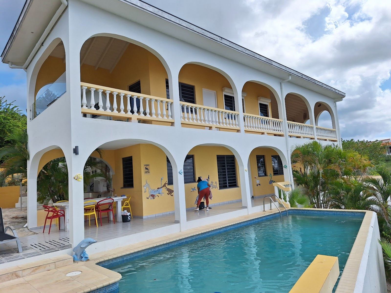 A sheltered leeward cove in Curacao with calm clear turquoise water and soft sand