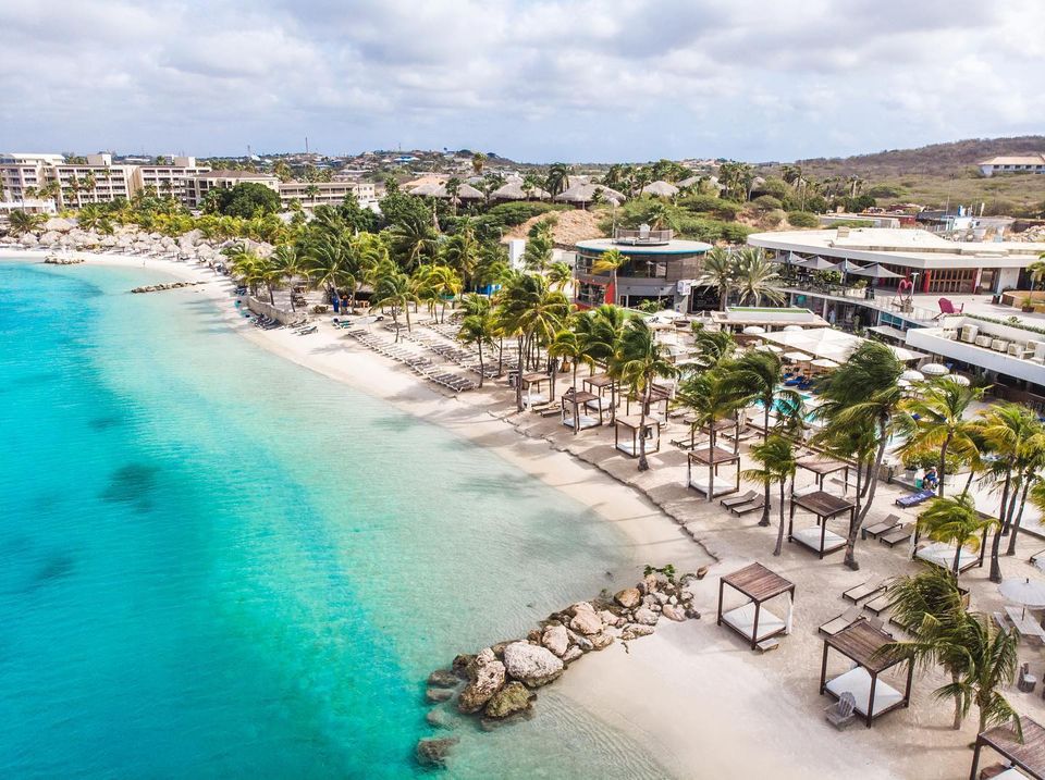 Beach beds and turquoise water at Mambo Beach on Curacao