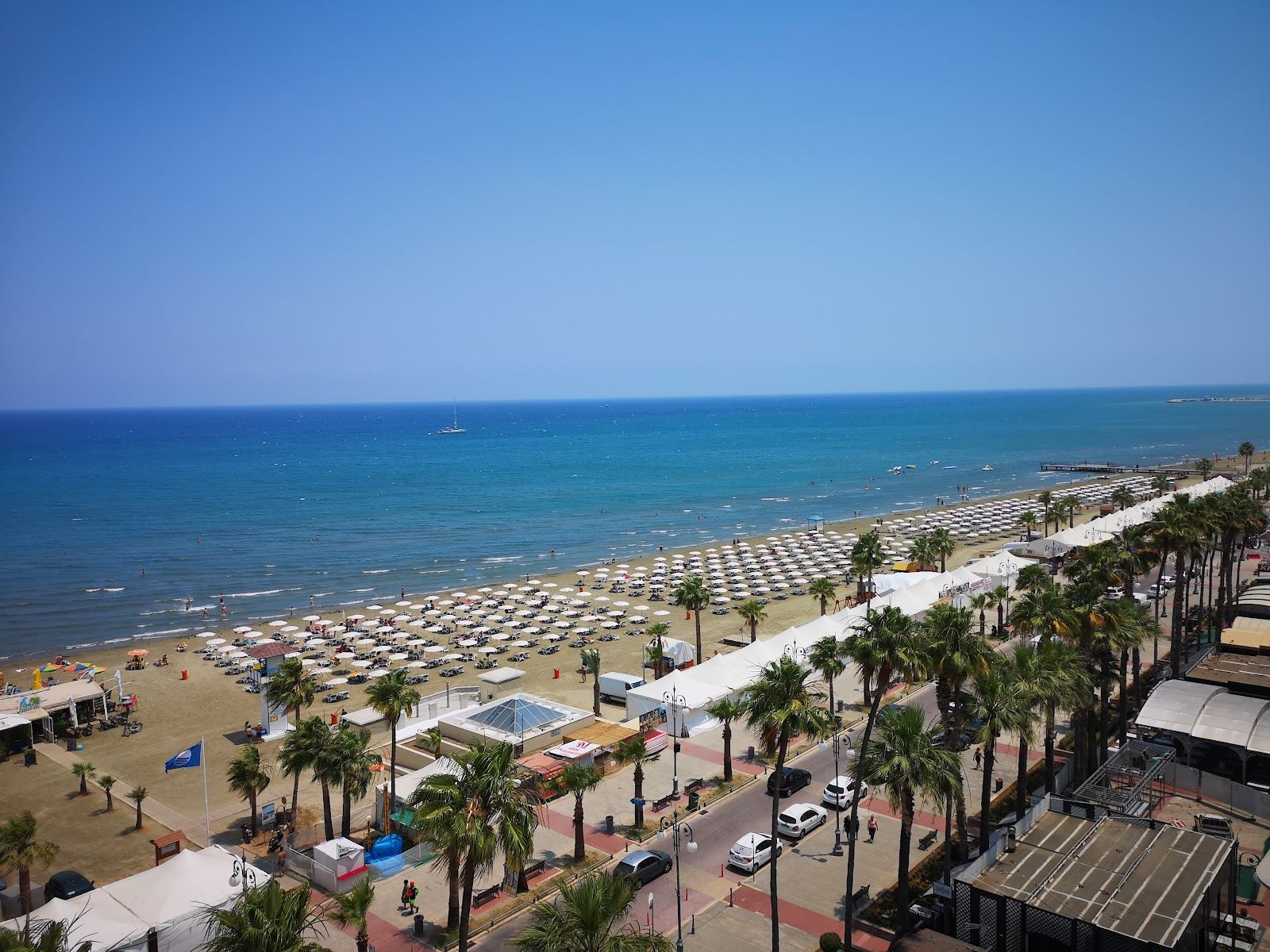 Palm lined promenade and calm water along Finikoudes beach in Larnaca Cyprus
