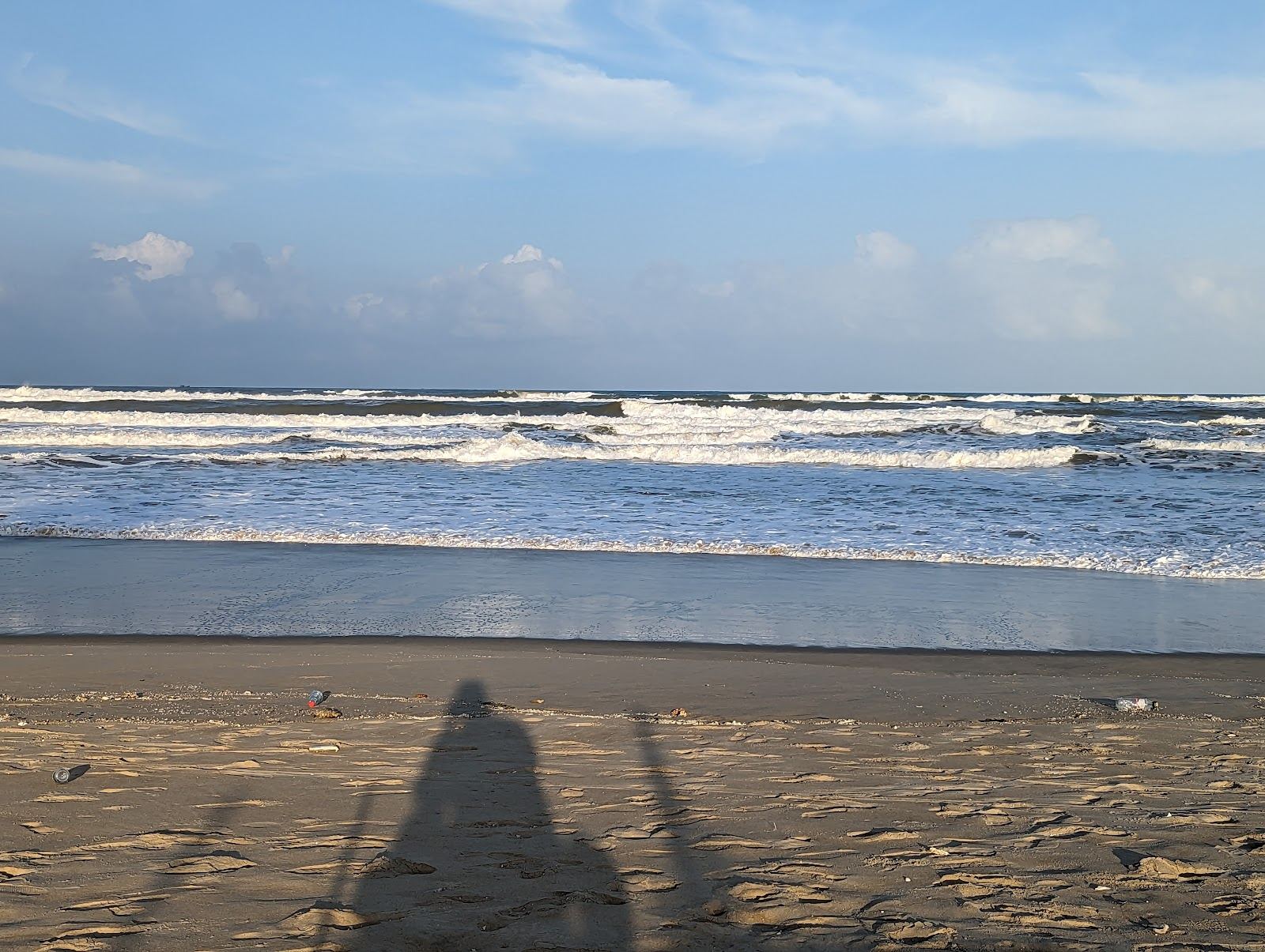 Fine pale sand and gentle surf along the long shore below the Marble Mountains in Da Nang, Vietnam