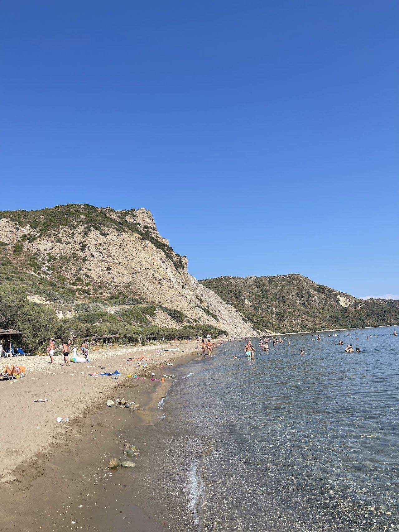 Clear shallow water and quiet sand with simple tavernas at Dafni beach in the marine park of Zakynthos