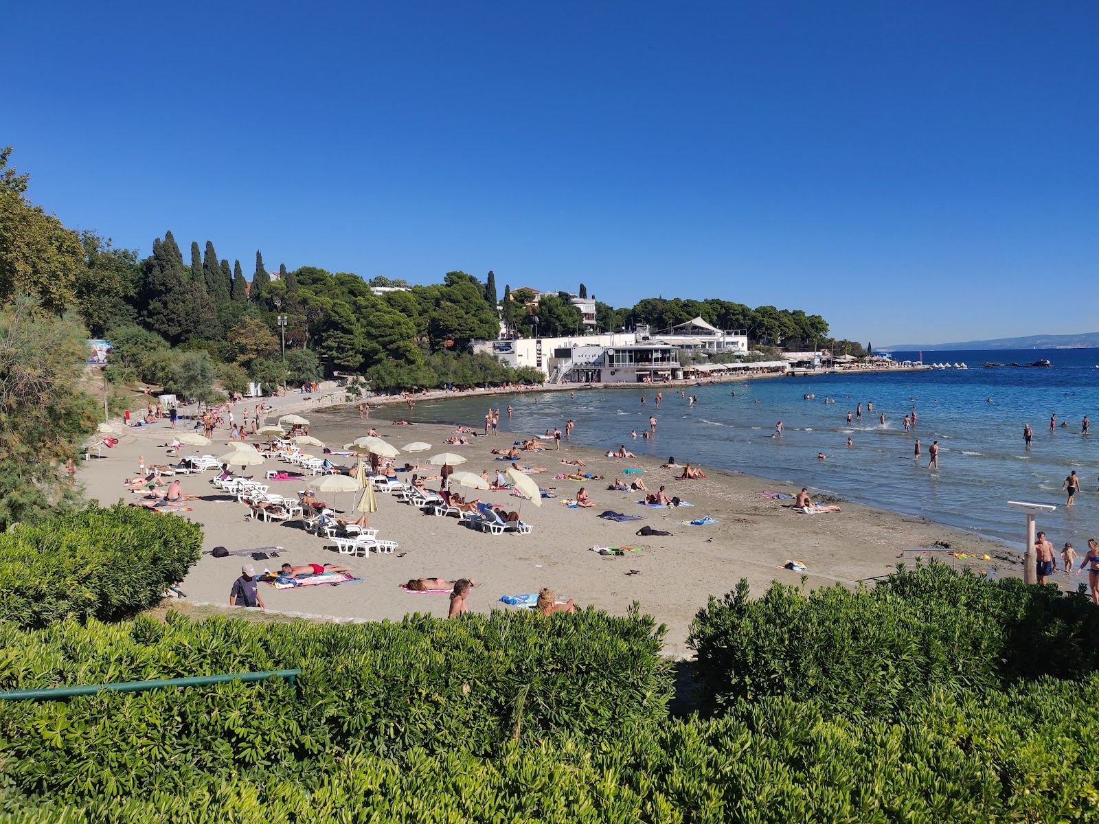 Pale shallow water and a crowded city beach at Bacvice in Split on the Dalmatian Coast