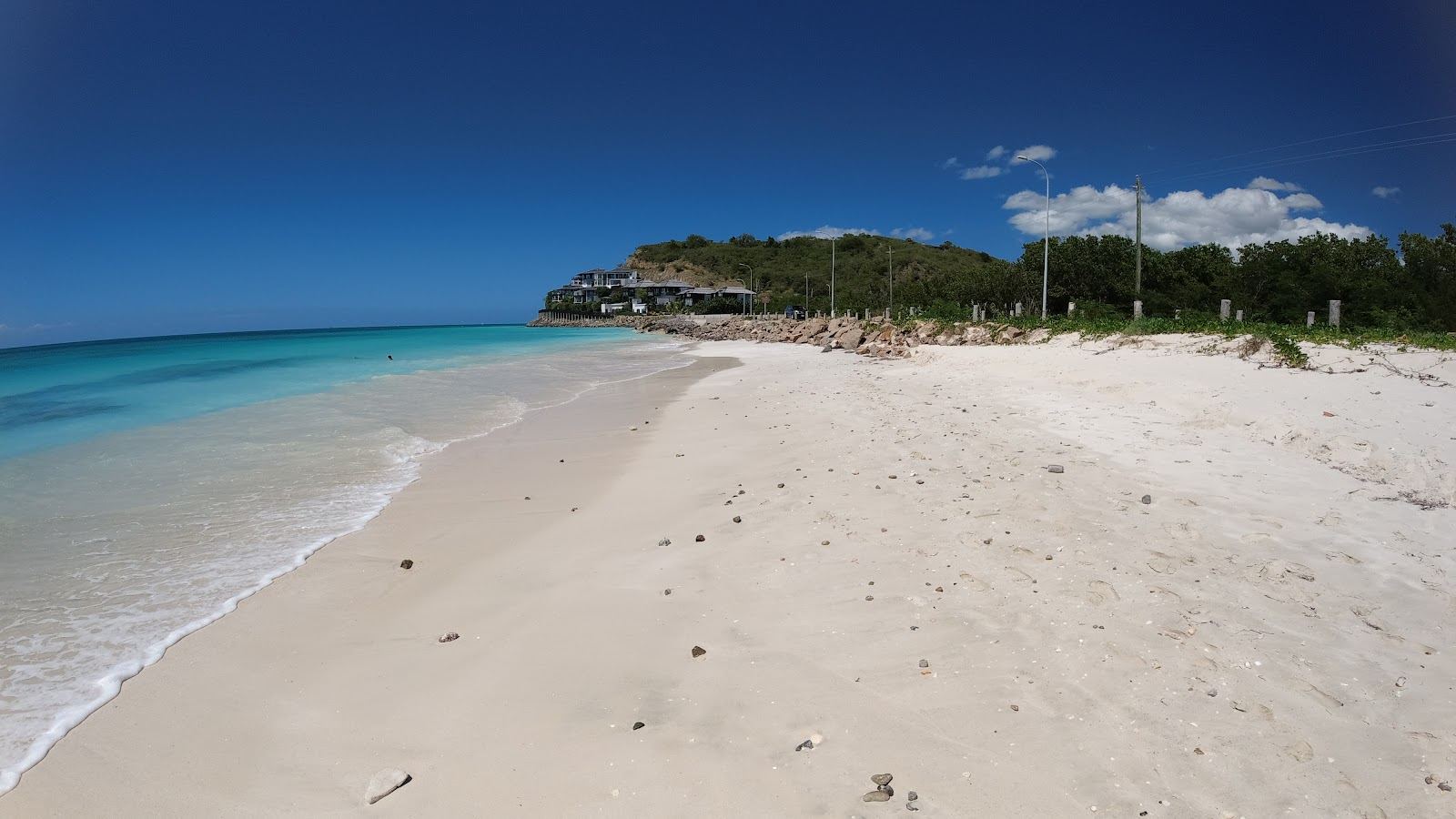 The long pale sand and calm clear water of Darkwood Beach on the southwest coast of Antigua