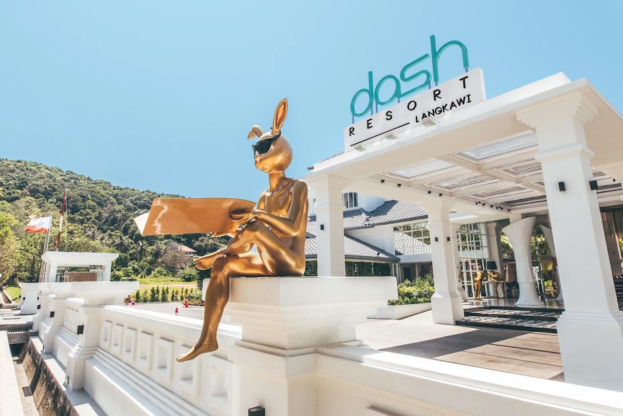 Infinity pool and loungers at Dash Beach Club looking out over Pantai Tengah in Langkawi