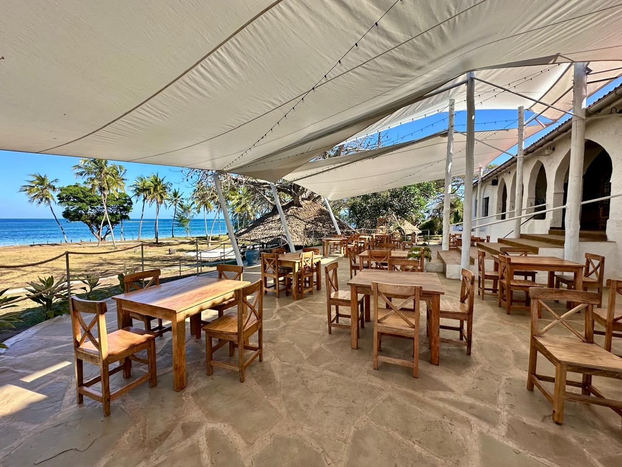 White sand, palms and turquoise Indian Ocean water at a beach bar on Diani Beach, Kenya