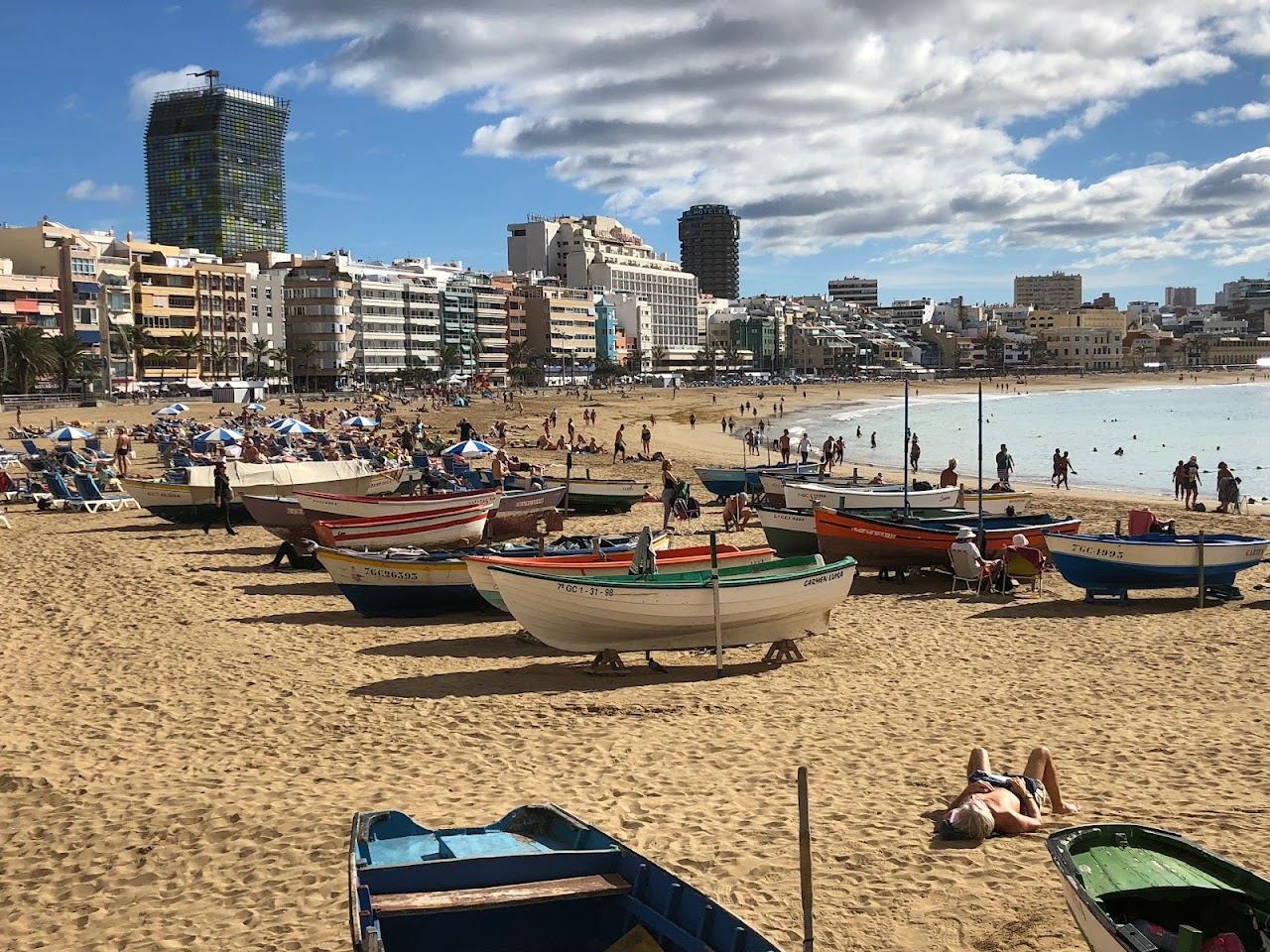 A long golden city beach with a cafe lined promenade at Las Canteras in Las Palmas Gran Canaria