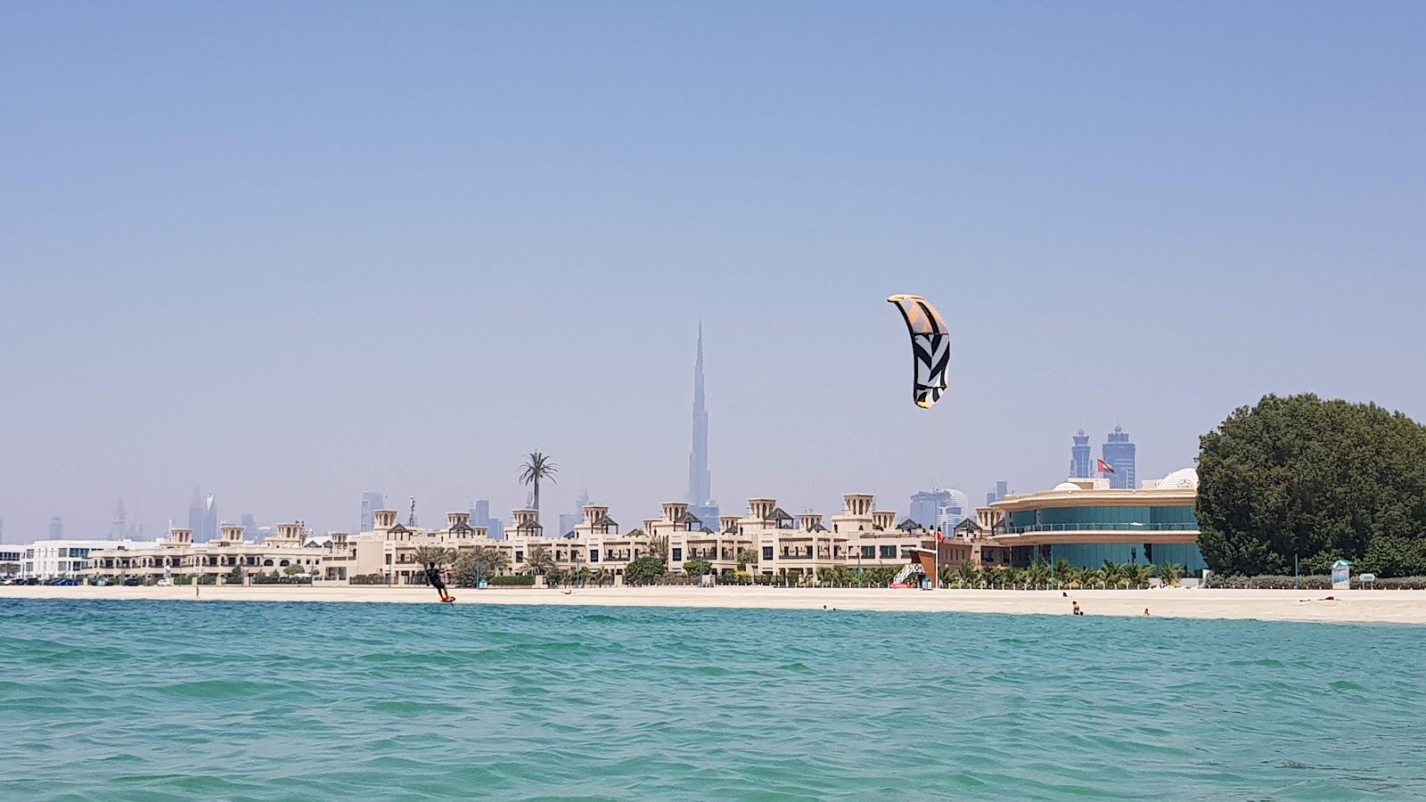 Calm Gulf water and clean public sand at Kite Beach in Jumeirah, Dubai