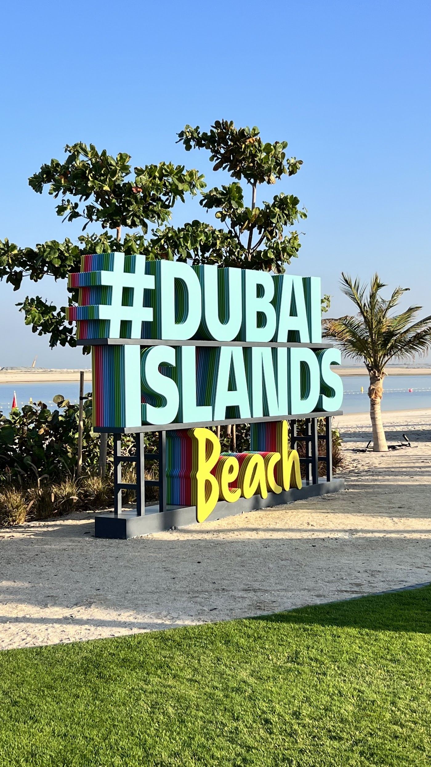 Clear shallow Gulf water over sand and rock at a Dubai beach