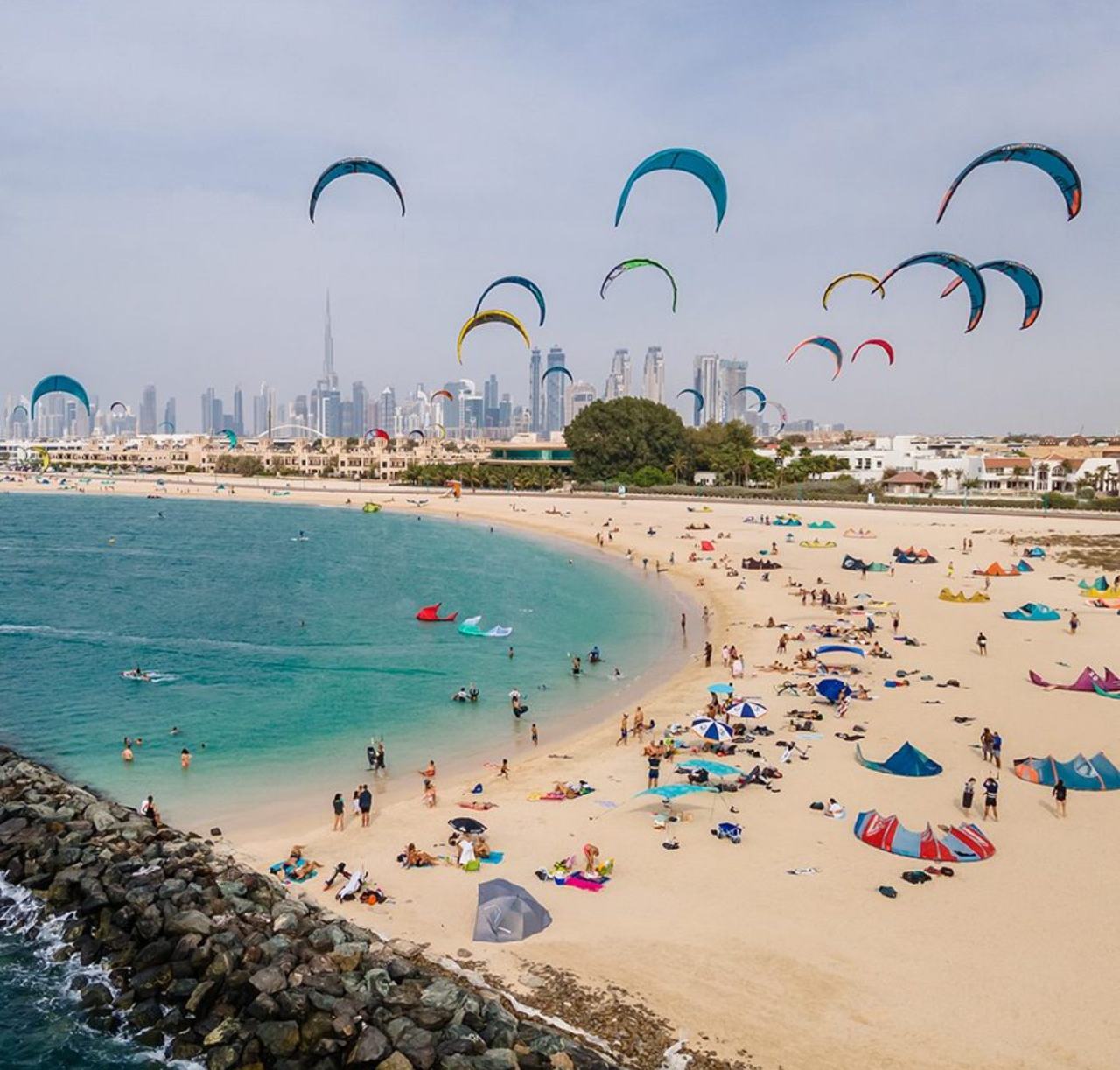 Kitesurfers and watersports on the wide open sand of Kite Beach in Dubai
