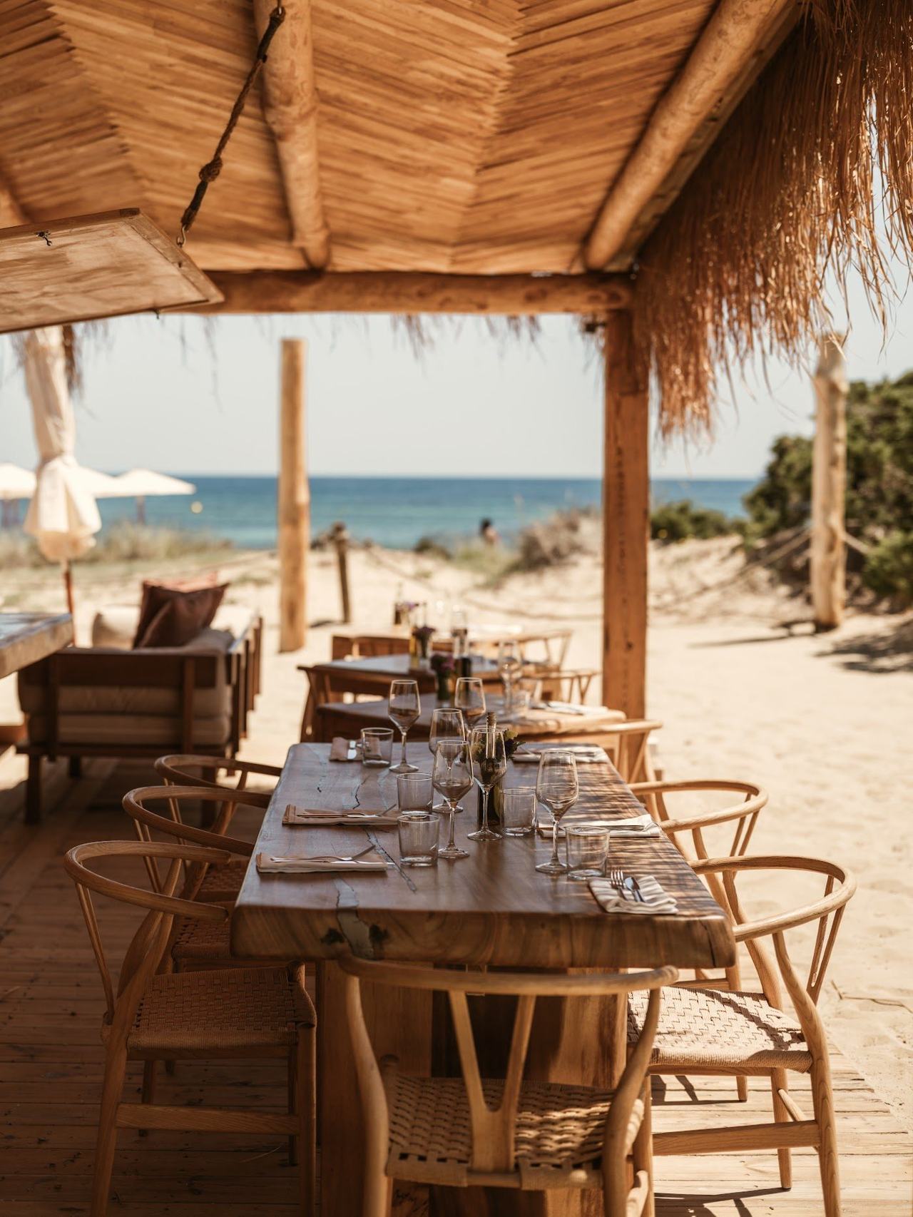 Whitewashed terrace and loungers above the sand at El Chiringuito, Es Cavallet