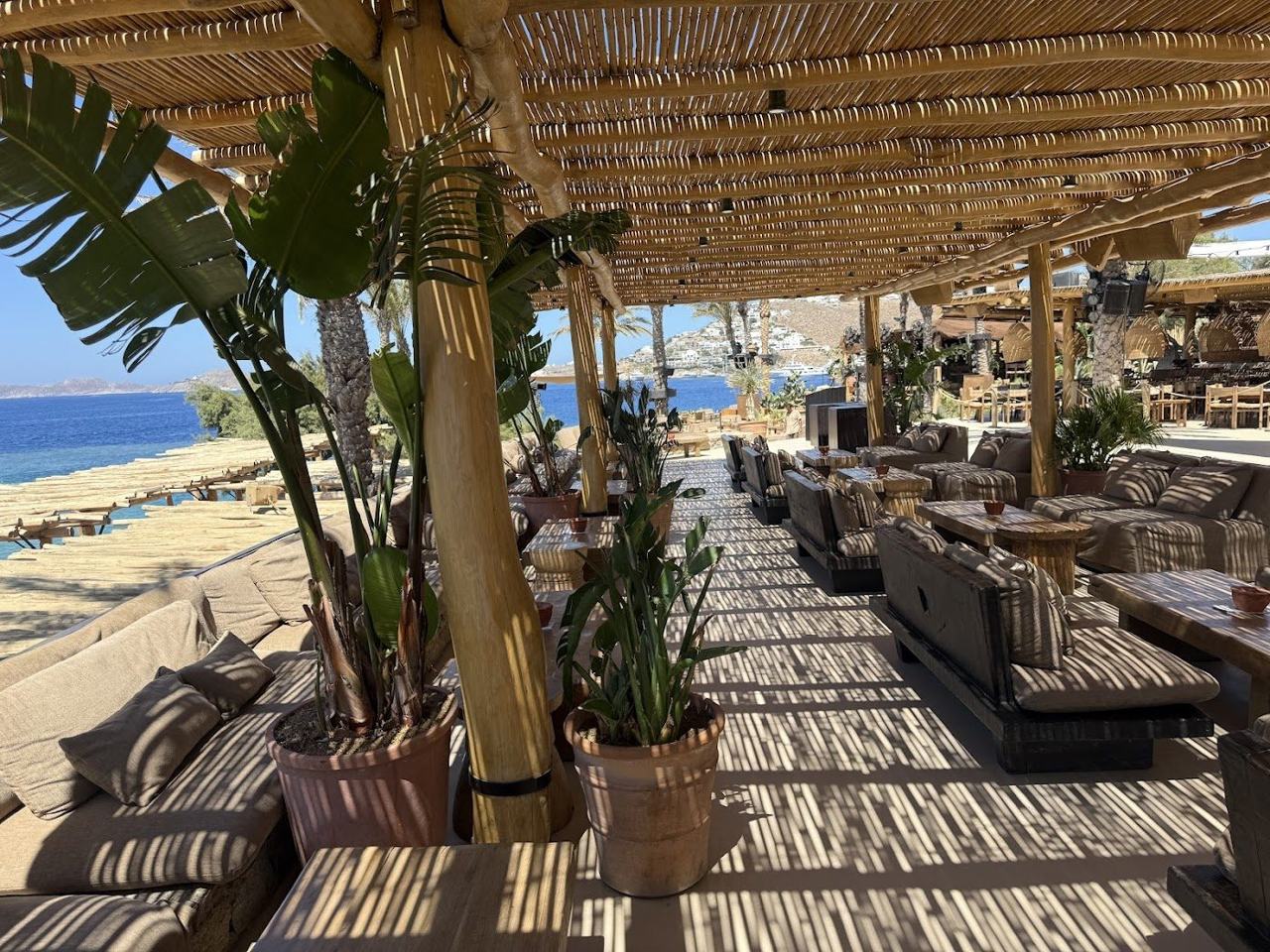 Driftwood daybeds and a sunset crowd at Scorpios on Mykonos
