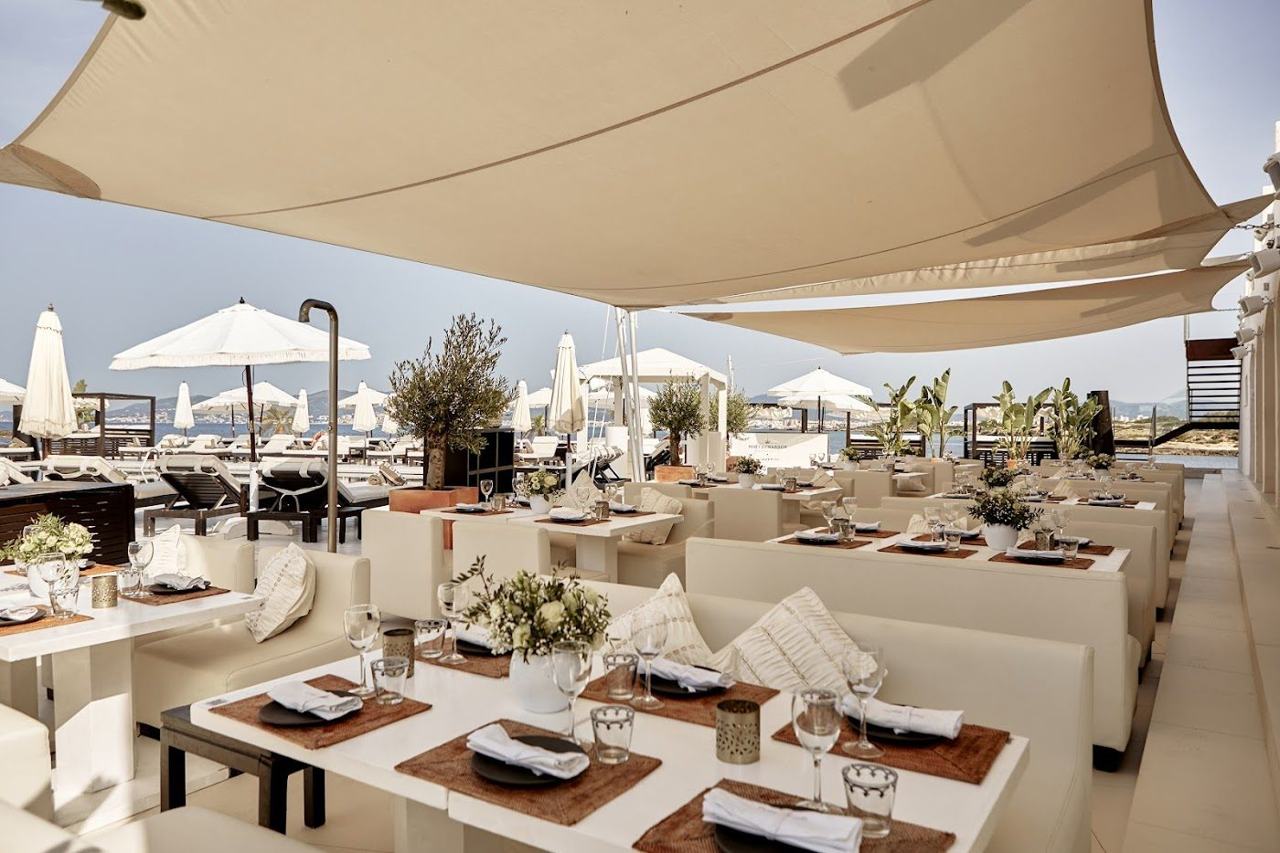 White loungers around the sea facing pool deck at Purobeach near Palma