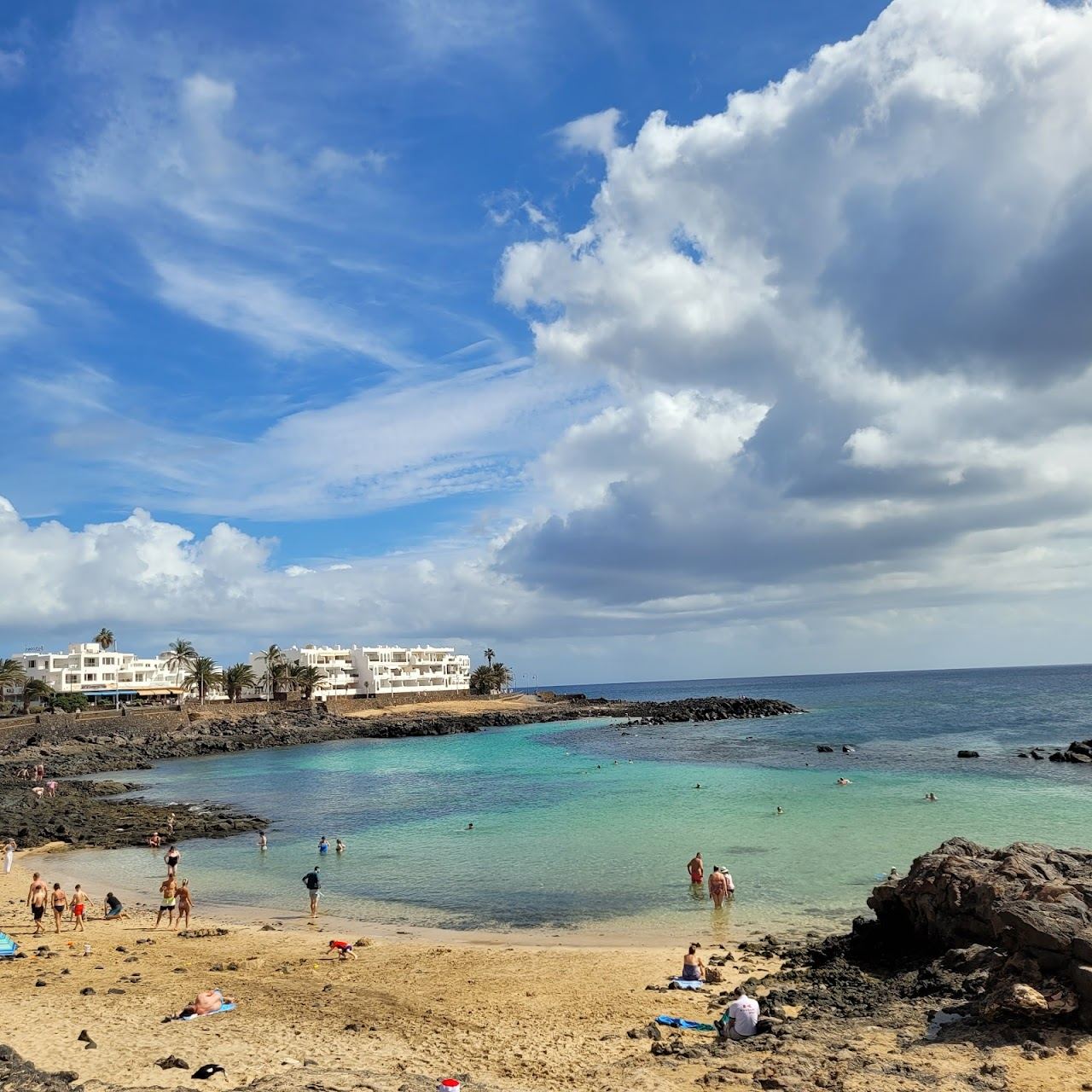 Small sheltered reef lagoon with calm shallow water at El Jablillo beach in Costa Teguise, Lanzarote