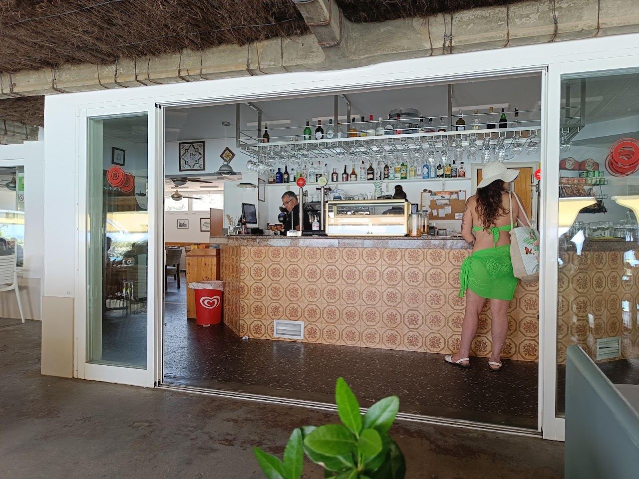 Beachfront terrace of Es Bruc restaurant on the sand at Sant Tomas in Menorca