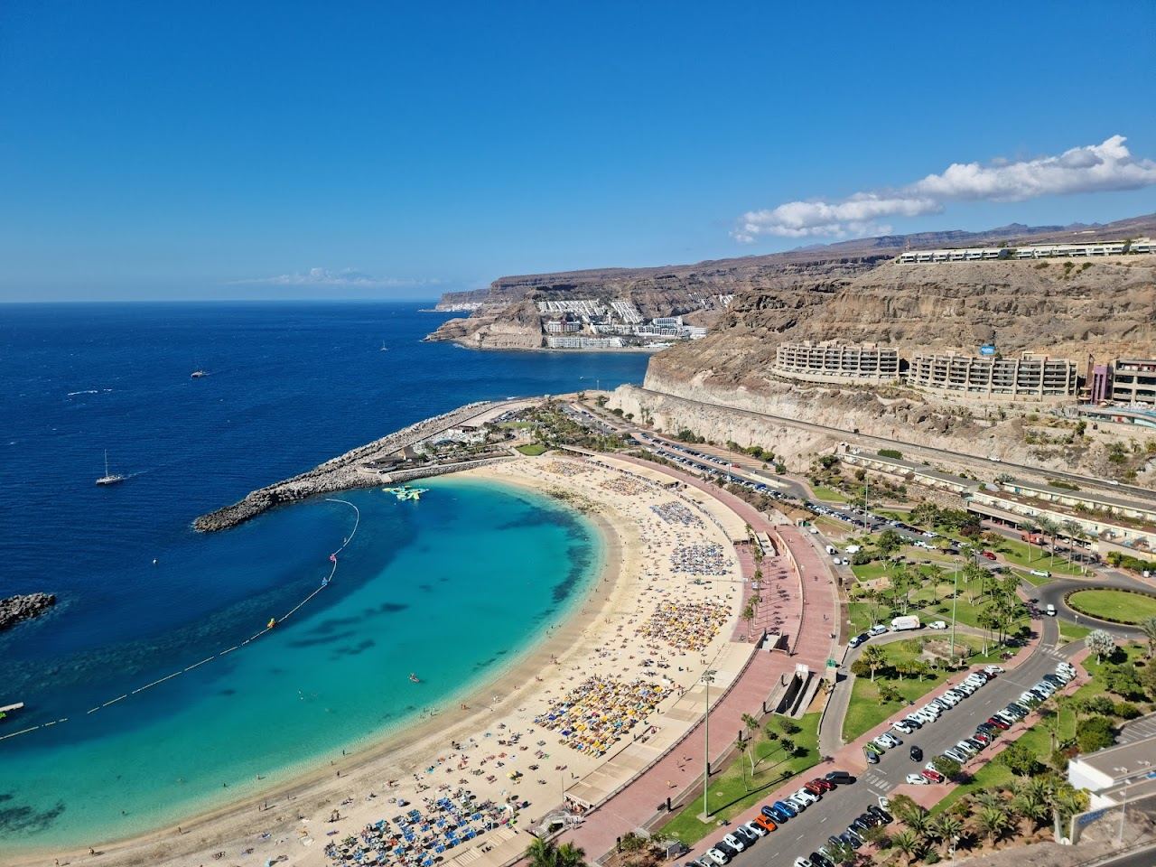 The sheltered horseshoe of imported pale sand and calm water at Amadores