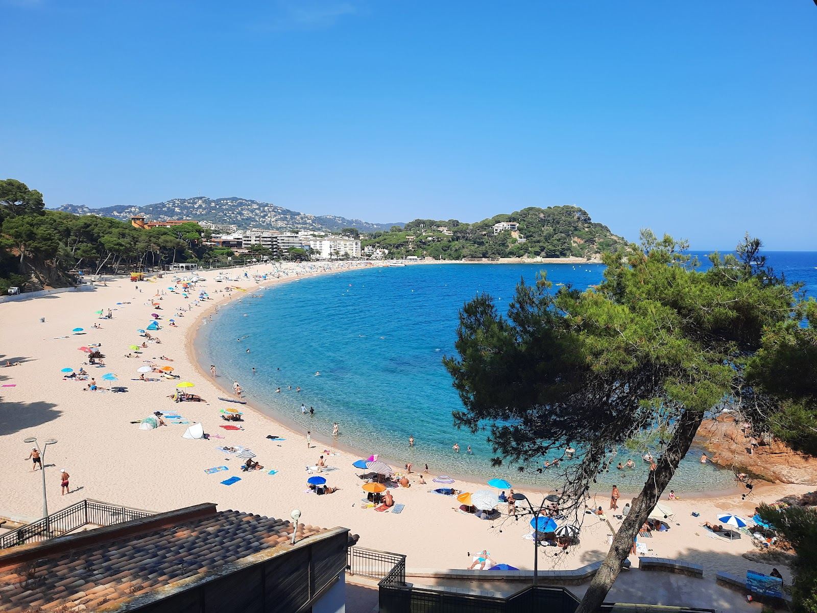 The sheltered curve of Platja de Fenals and its seafront near Lloret de Mar