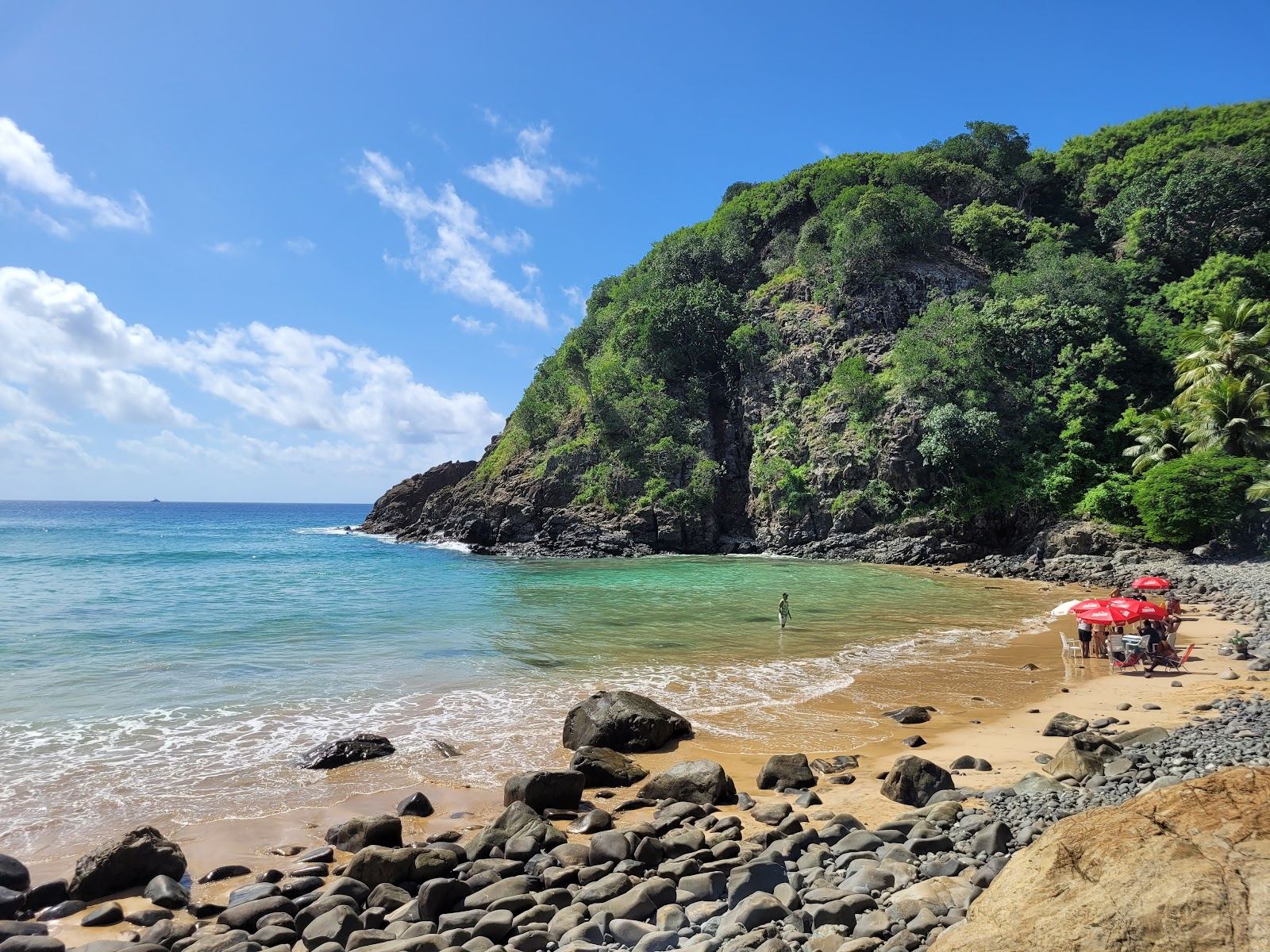 Golden sand, black volcanic rocks and clear water at Praia do Cachorro below the village in Fernando de Noronha