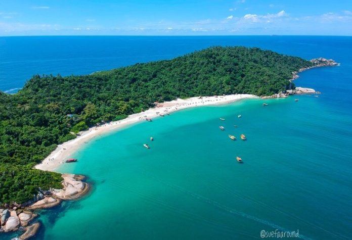 The long fine sand and Atlantic surf of Campeche beach in Florianopolis