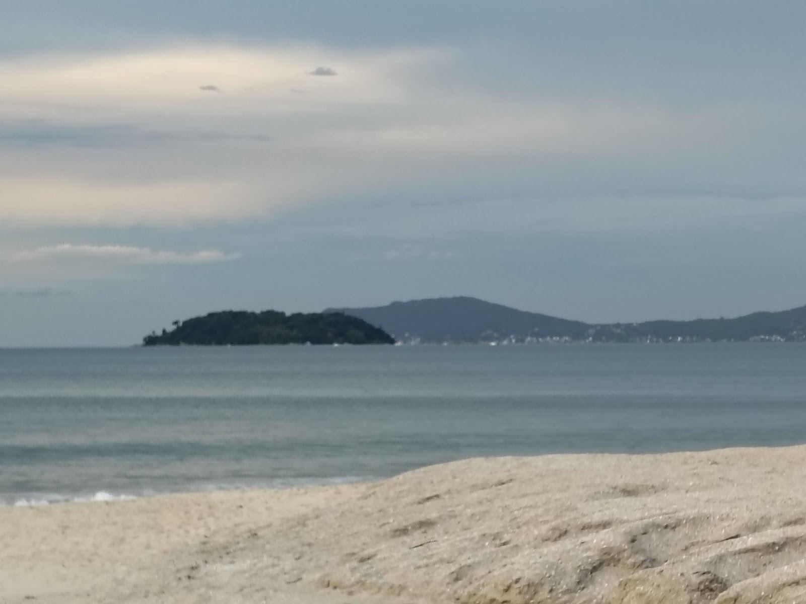 The calm sand and gentle water of a north coast family beach in Florianopolis Brazil