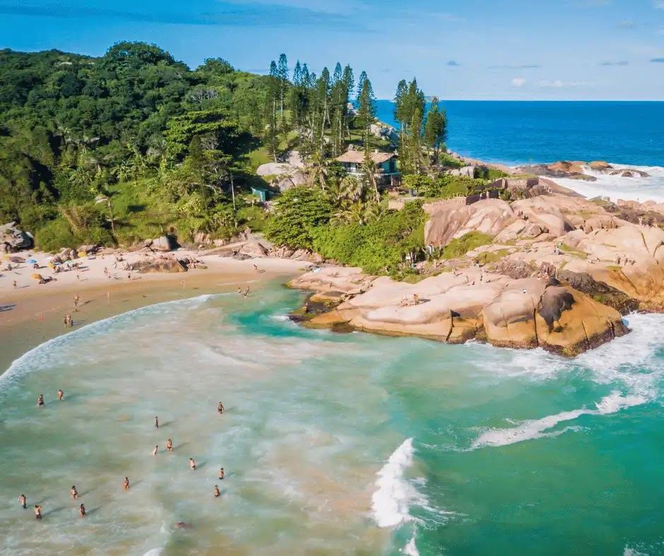 The Atlantic surf and tall golden dunes behind Praia da Joaquina in Florianopolis