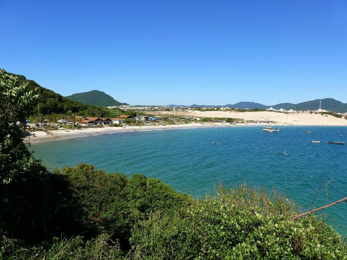 Fine white sand and warm blue water along the long northern beach of Praia dos Ingleses in Florianopolis