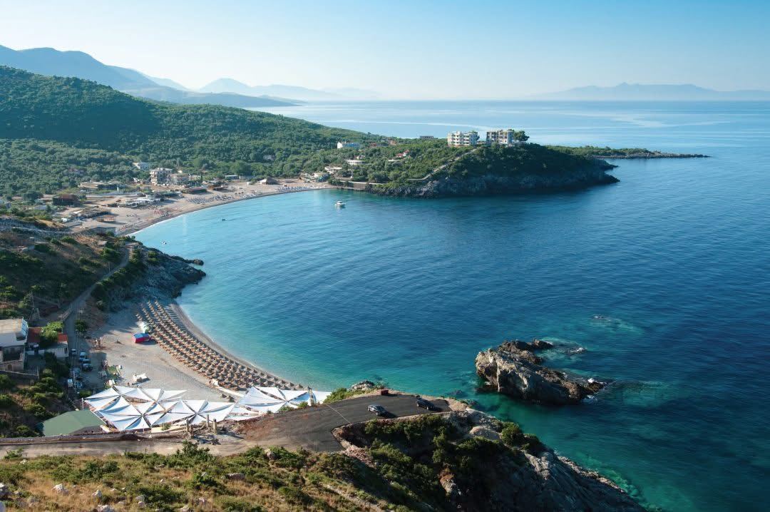 Clear Ionian water and pebble sand in the Jale bay on the Albanian Riviera below Folie Marine