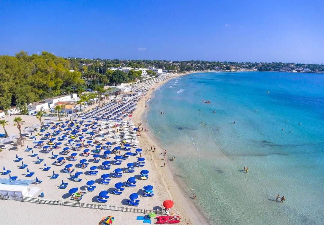 Pale sand and shallow turquoise water at Fontane Bianche south of Syracuse Sicily