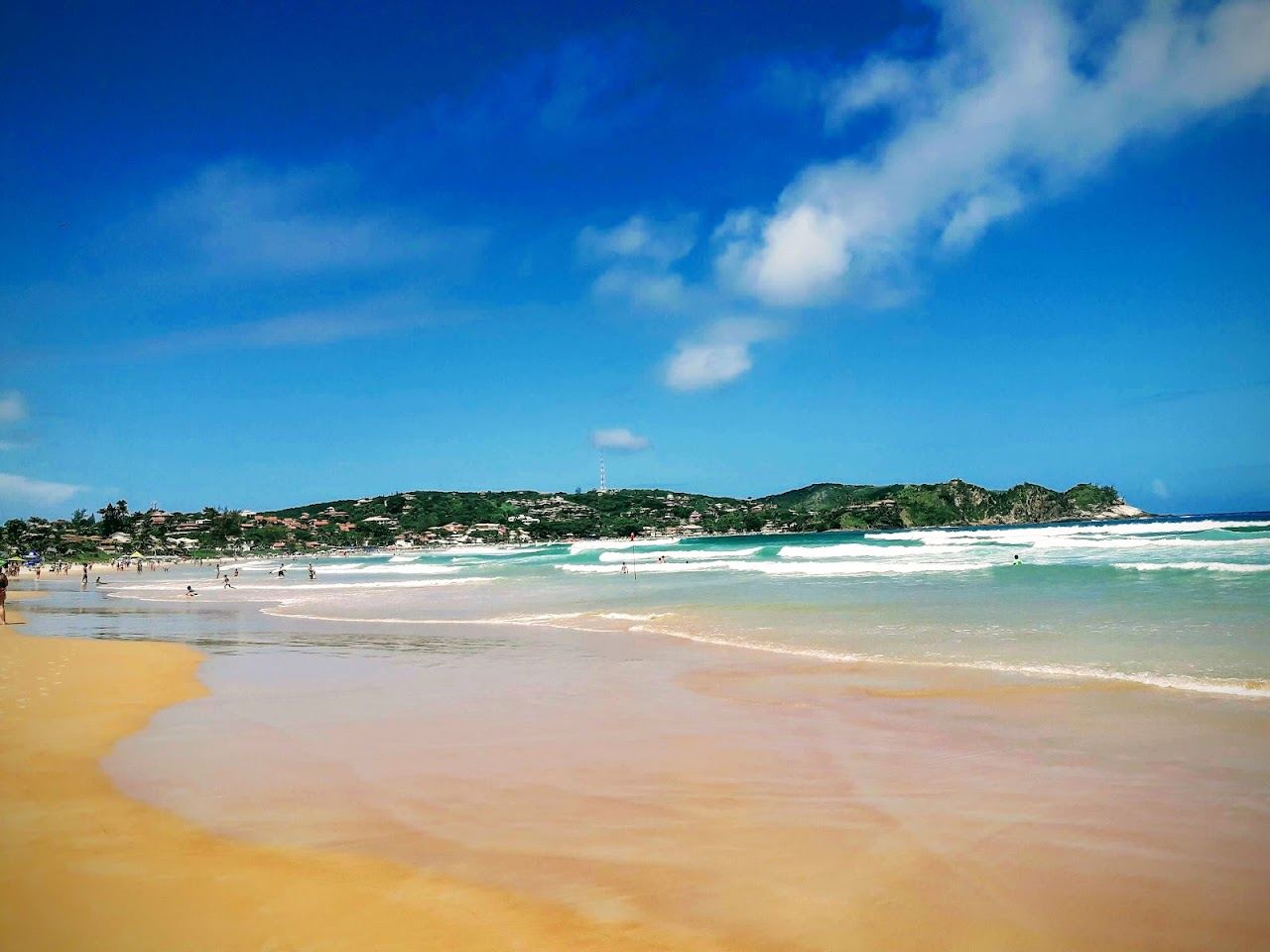 The long golden sand and surf of Geriba Beach in Buzios, Brazil