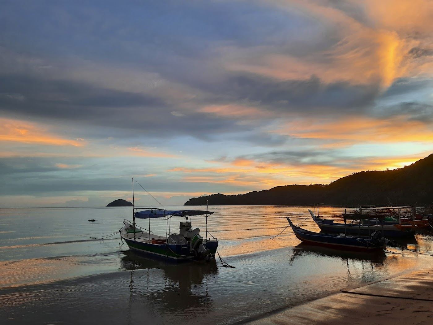 Open sea horizon and fishing boats at anchor off Gertak Sanggul Beach in Penang